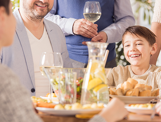 Group of people gathered around table of food