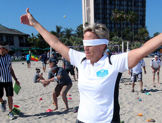 Woman with arms open wide playing sand games