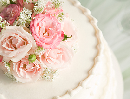 Wedding cake with a custom spray of pink flowers
