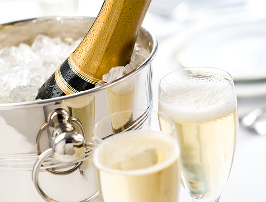 Champagne in ice bucket with two glasses