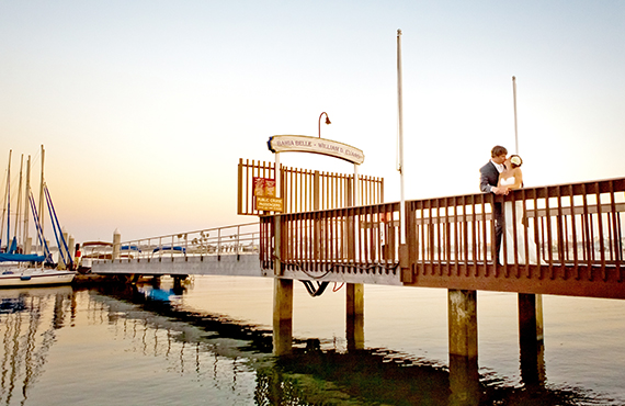 Couple embracing on deck looking out to Mission Bay