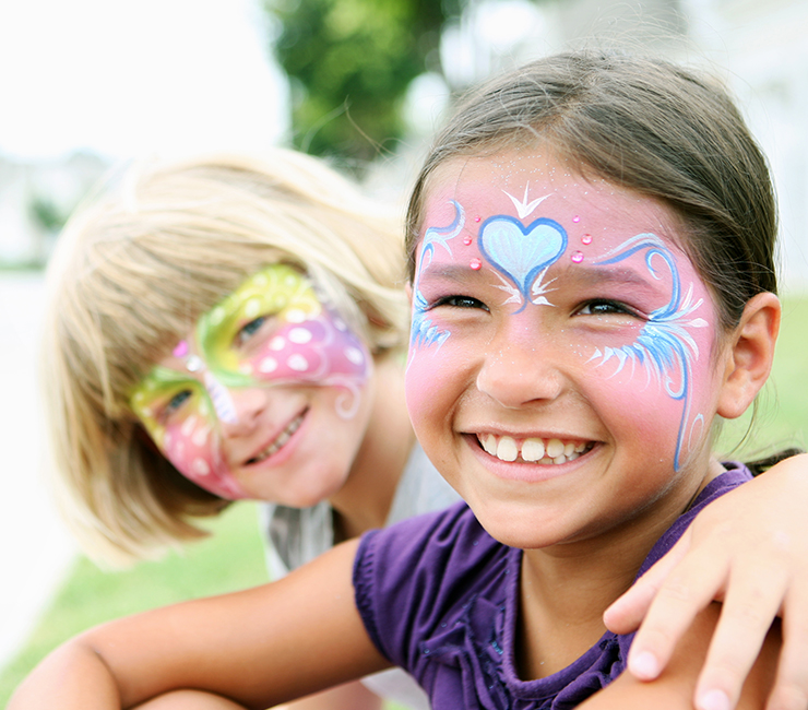 Kids smiling with painted faces at the Catamaran Resort Hotel Kids Keiki Club.