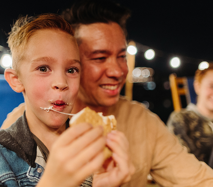A guest and his son enjoying s’mores at the beach on Mission Bay.
