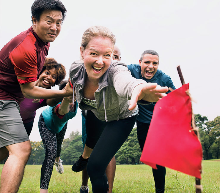 Coworkers racing to capture the flag during a team building activity in San Diego at the Catamaran Resort Hotel.