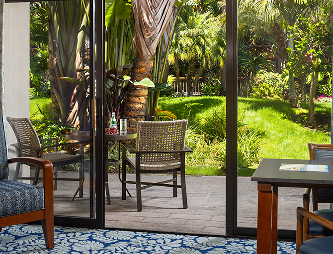 View of the lush tropical gardens from the Resort Room private patio at the Catamaran Resort Hotel in San Diego beaches area.