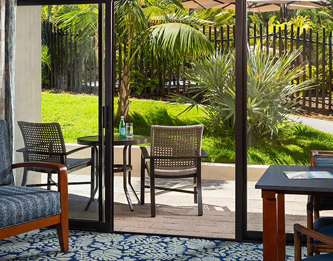 View of the poolside room at Catamaran Resort Hotel and Spa looking out onto the patio.