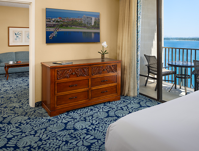 Separate bedroom with king bed with views of Mission Bay from the Bay View Suite at the Catamaran Resort Hotel in San Diego beaches.