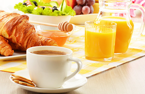 croissant and orange juice on a tray