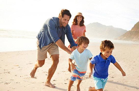 Family Playing on Beach While on Vacation in San Diego
