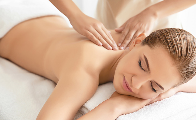 Relaxed woman getting a Catamaran Signature Massage at the Catamaran Spa
