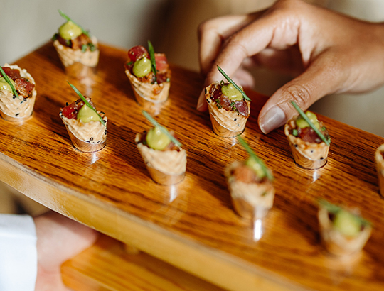 hors d'oeuvres served on wooden board at a cocktail reception at the Catamaran Resort
