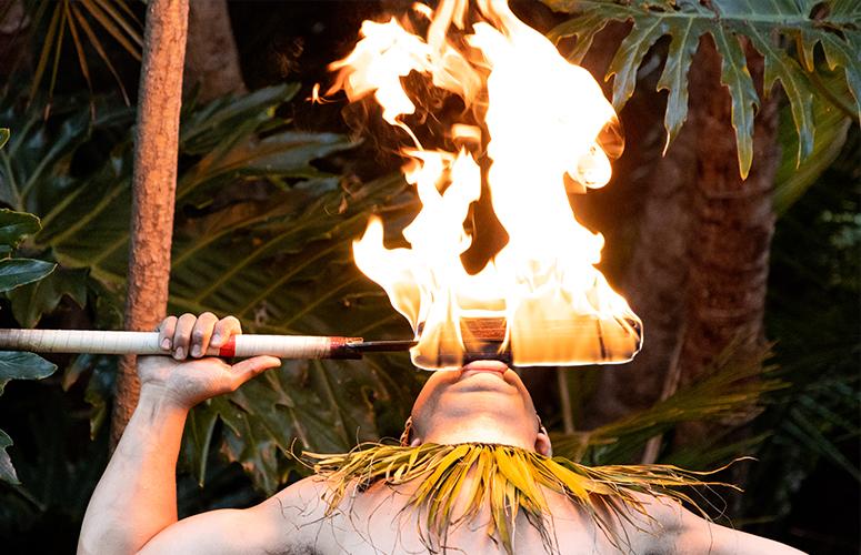 A Polynesian dancer performing a fire show at the Catamaran Resort Hotel and Spa by Pacific Beach, San Diego, CA