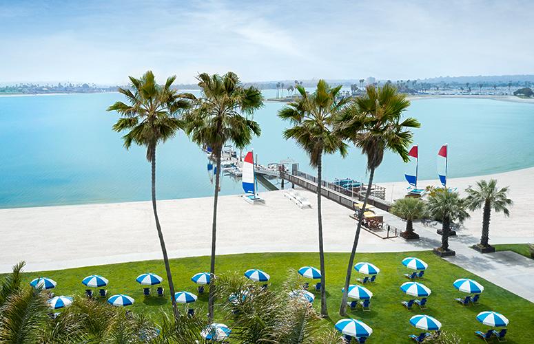 Beach chairs and umbrellas with view of Mission Bay