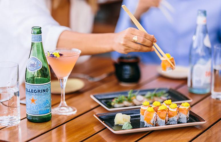 A table setting with sushi and drinks