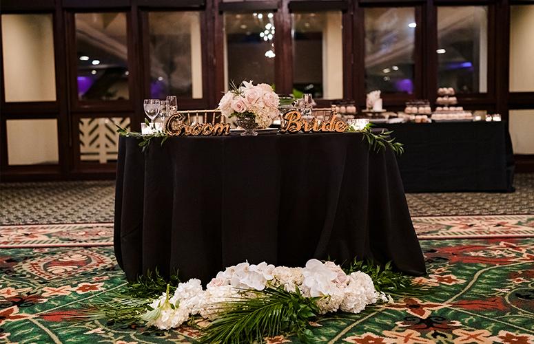 The bride and groom’s table at the classic wedding reception at the Catamaran Resort Hotel in San Diego.